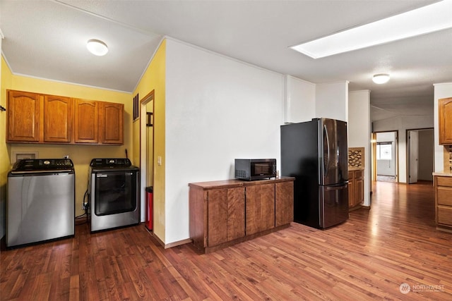 kitchen with washer and clothes dryer, stainless steel refrigerator, dark hardwood / wood-style flooring, and lofted ceiling