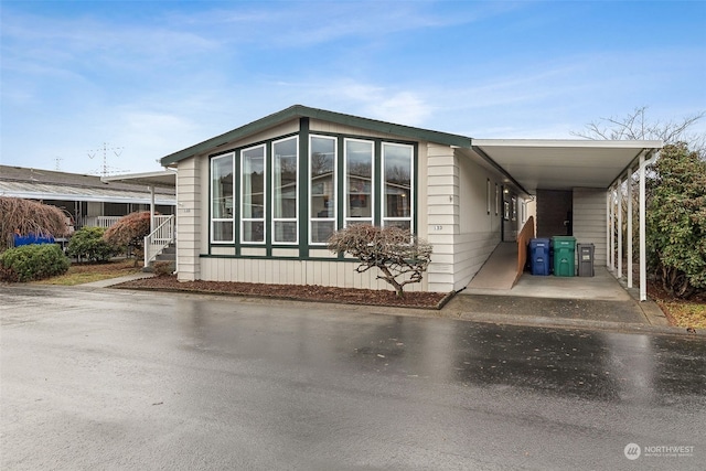 view of side of property featuring a carport