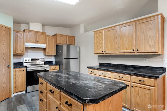 kitchen featuring appliances with stainless steel finishes, dark hardwood / wood-style floors, a kitchen island, and light brown cabinets