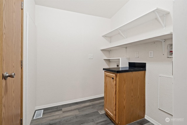 bar with dark hardwood / wood-style flooring