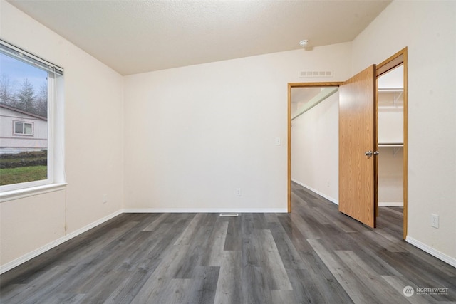 unfurnished room featuring dark hardwood / wood-style flooring