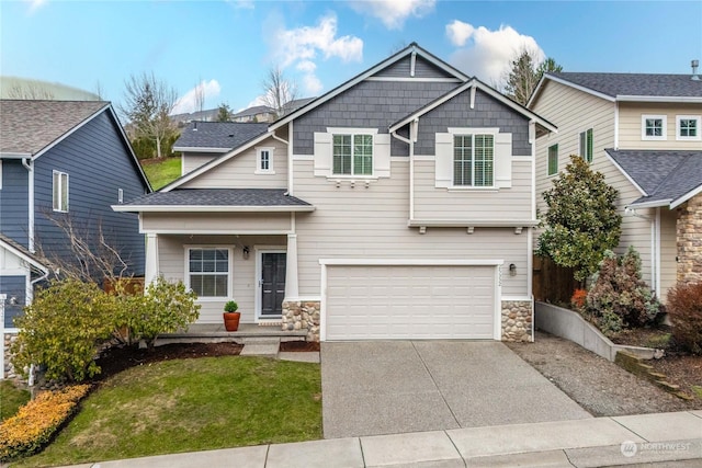 craftsman-style home featuring a front yard and a garage