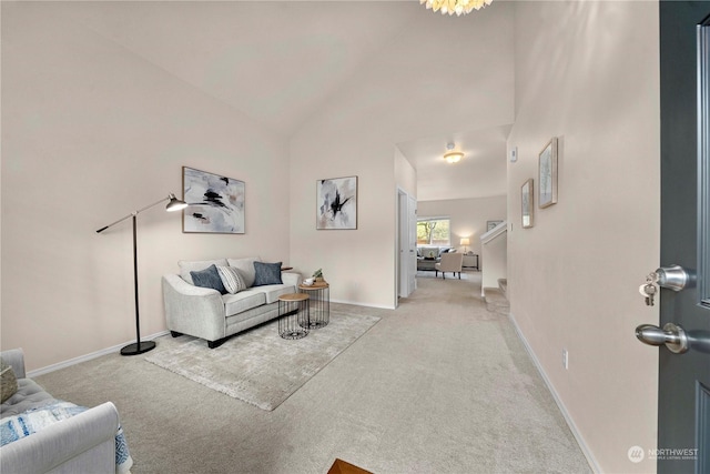 living room with high vaulted ceiling and light carpet