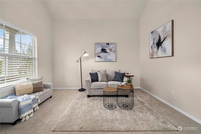 living area with light carpet and lofted ceiling