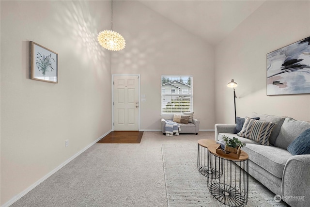 living room featuring a chandelier, high vaulted ceiling, and carpet flooring