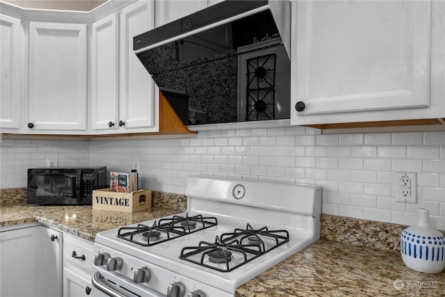 kitchen with white cabinets, backsplash, gas range gas stove, and light stone countertops