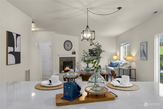 interior space with a fireplace and an inviting chandelier