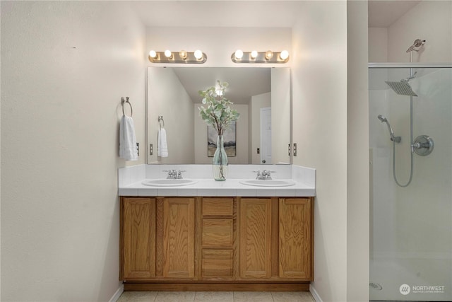 bathroom with tile patterned flooring, a shower with shower door, and vanity