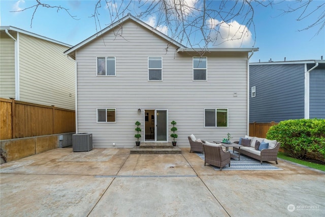 back of house featuring central AC unit, an outdoor living space, and a patio