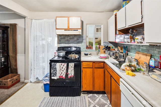 kitchen featuring tasteful backsplash, dishwashing machine, black electric range, and white cabinets