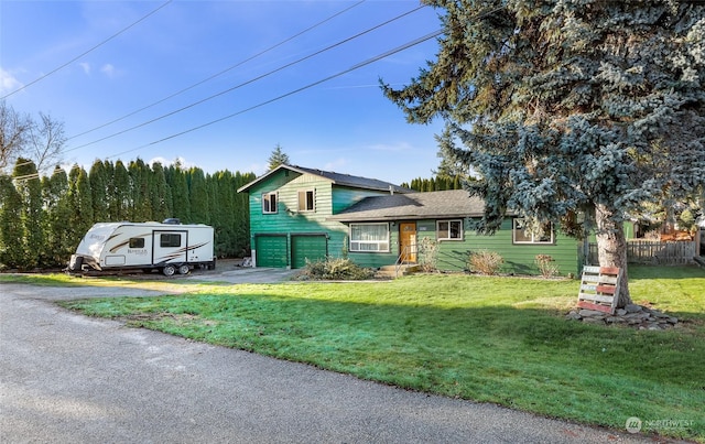 view of front facade with a garage and a front lawn