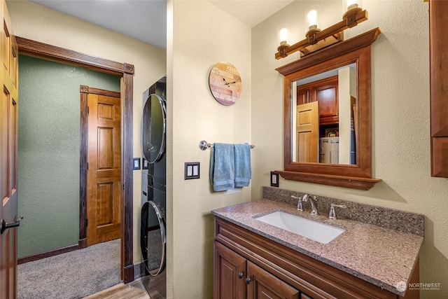 bathroom with vanity and stacked washer / drying machine