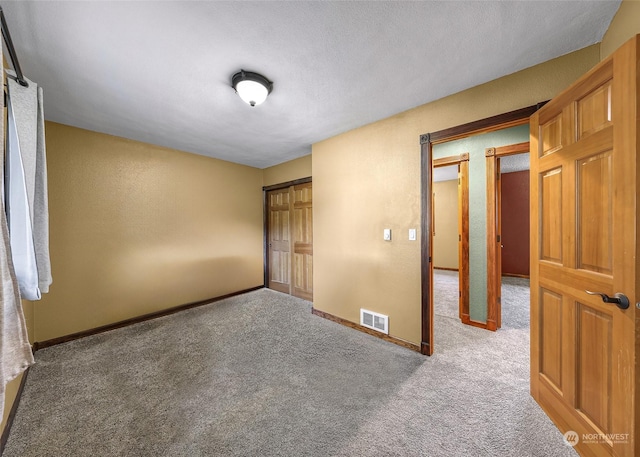 unfurnished bedroom with carpet floors and a closet