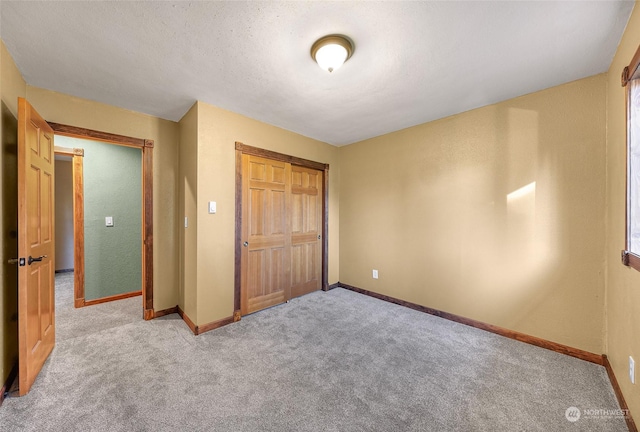 unfurnished bedroom with light carpet and a closet