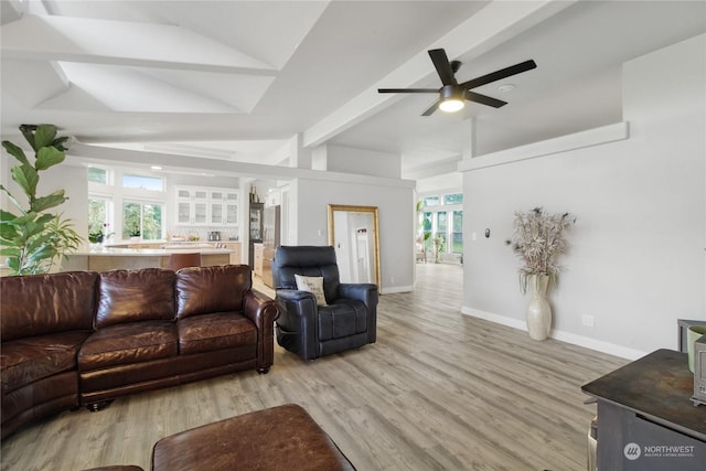 living room with lofted ceiling with beams, light hardwood / wood-style floors, and ceiling fan