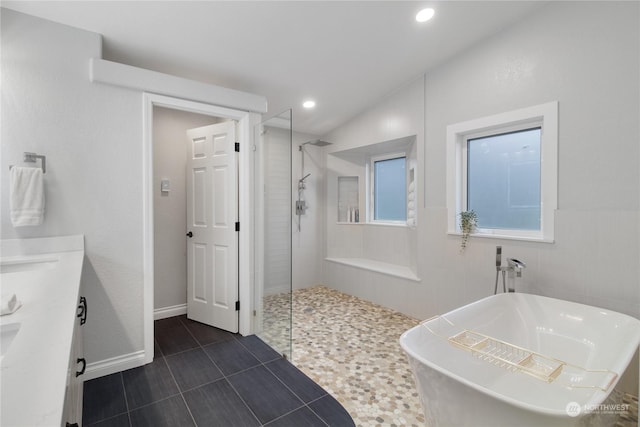 bathroom featuring tile patterned floors, vanity, plus walk in shower, and vaulted ceiling