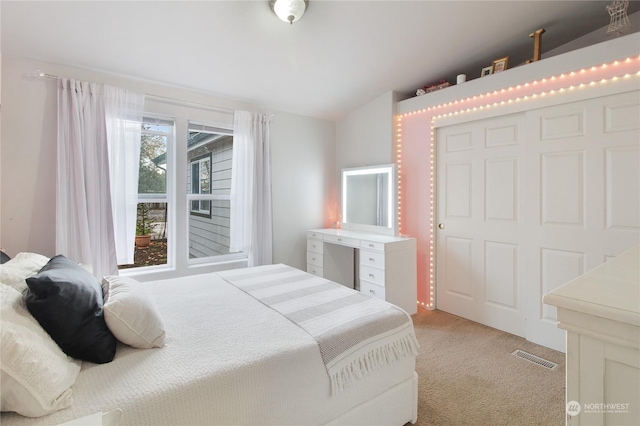 bedroom with light carpet and lofted ceiling