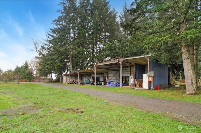 exterior space featuring an outdoor structure and a front yard