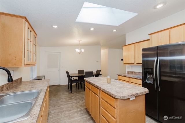 kitchen featuring light brown cabinetry, stainless steel fridge with ice dispenser, sink, and a kitchen island