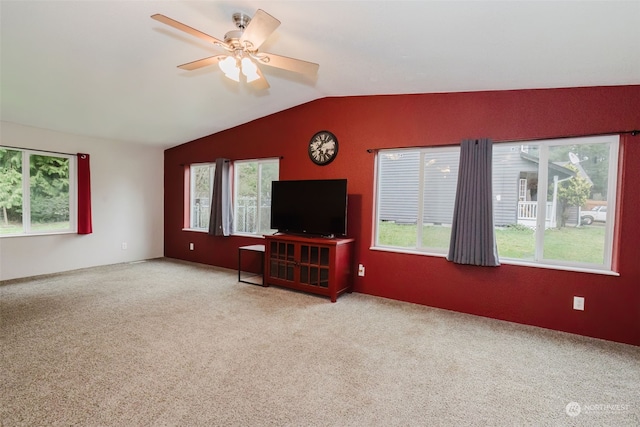 unfurnished living room with ceiling fan, light colored carpet, and lofted ceiling