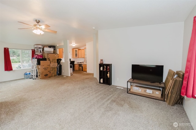 carpeted living room featuring ceiling fan