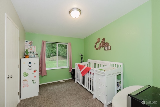 carpeted bedroom with a nursery area