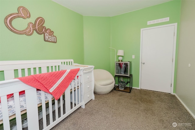 carpeted bedroom with a nursery area