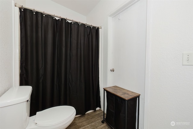 bathroom featuring hardwood / wood-style flooring and toilet