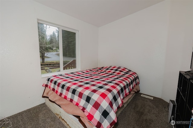 bedroom with dark colored carpet