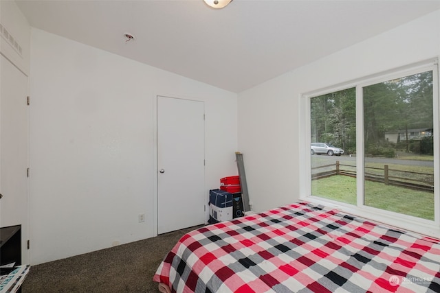 bedroom featuring vaulted ceiling and dark colored carpet