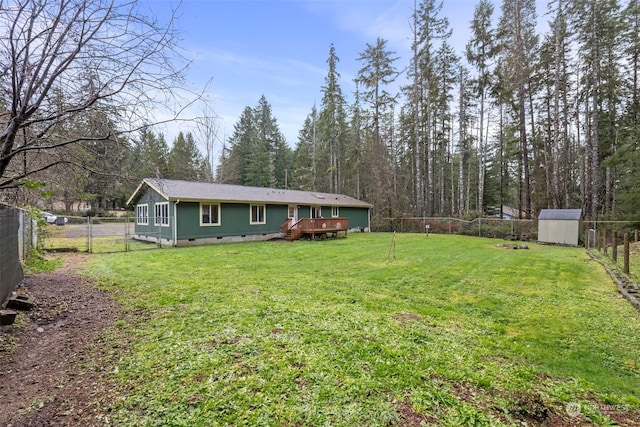 view of yard featuring a shed and a deck