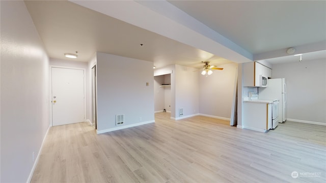 unfurnished living room with ceiling fan and light hardwood / wood-style floors