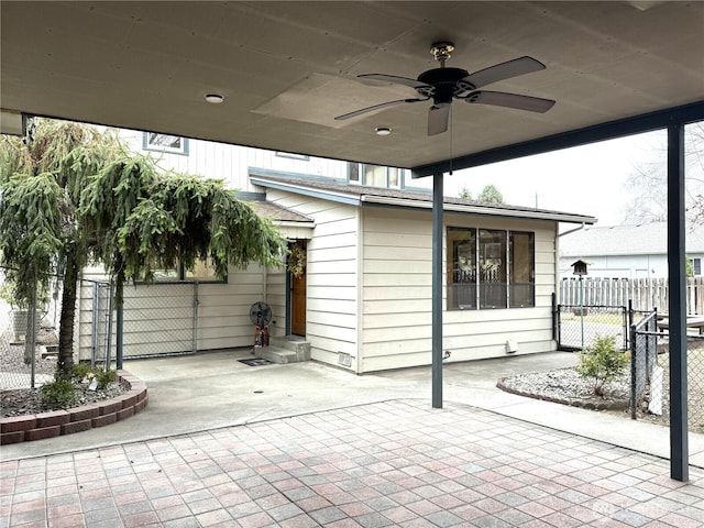 view of patio / terrace with fence, ceiling fan, entry steps, and a gate