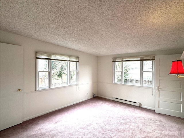 carpeted spare room featuring a baseboard heating unit, baseboards, and a textured ceiling