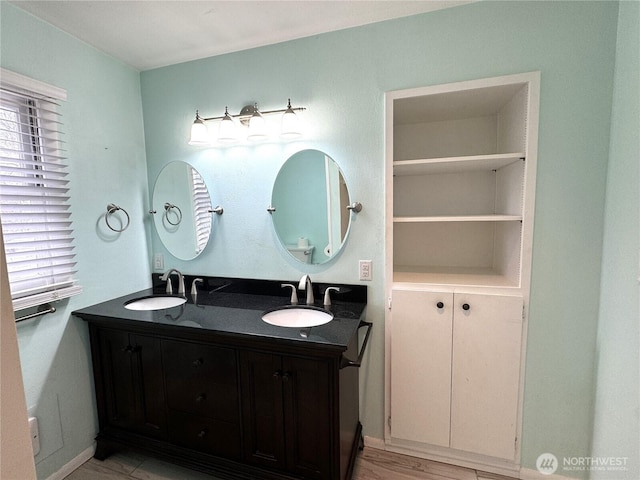 full bath with a sink and double vanity