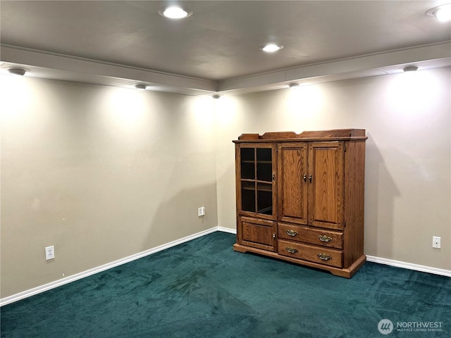 finished below grade area with dark colored carpet, baseboards, and recessed lighting