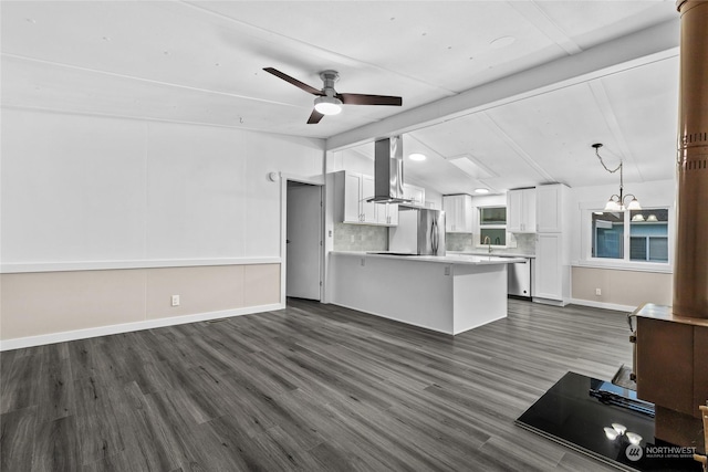 kitchen with dark hardwood / wood-style floors, appliances with stainless steel finishes, decorative light fixtures, island range hood, and white cabinetry