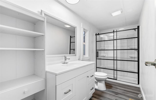 bathroom with hardwood / wood-style floors, vanity, and toilet