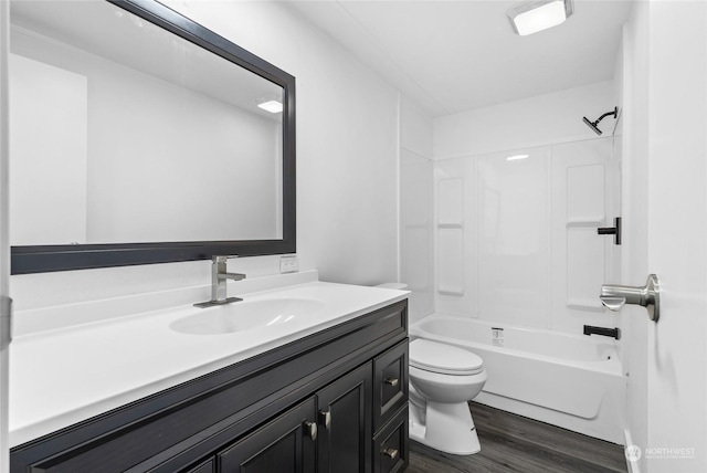 full bathroom featuring hardwood / wood-style flooring, vanity, shower / bathtub combination, and toilet