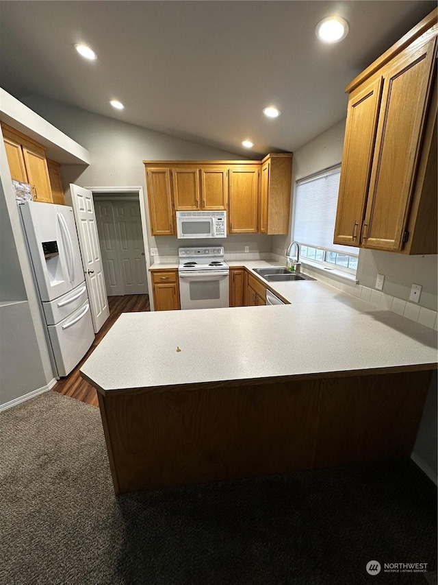 kitchen featuring kitchen peninsula, sink, hardwood / wood-style floors, and white appliances