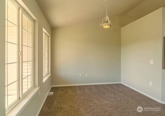 carpeted spare room featuring lofted ceiling