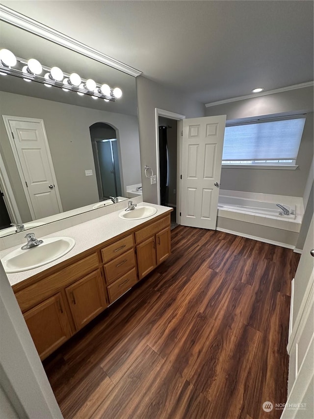 bathroom with plus walk in shower, vanity, and hardwood / wood-style flooring