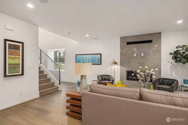 living room featuring a fireplace and light hardwood / wood-style flooring