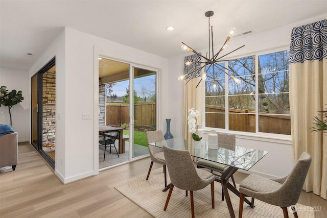 dining area featuring a chandelier and light hardwood / wood-style flooring