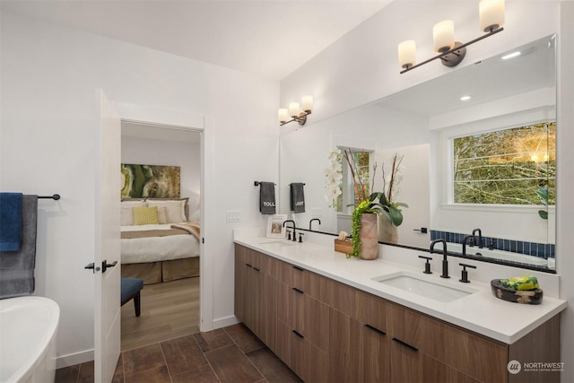 bathroom featuring wood-type flooring, vanity, and a bathtub