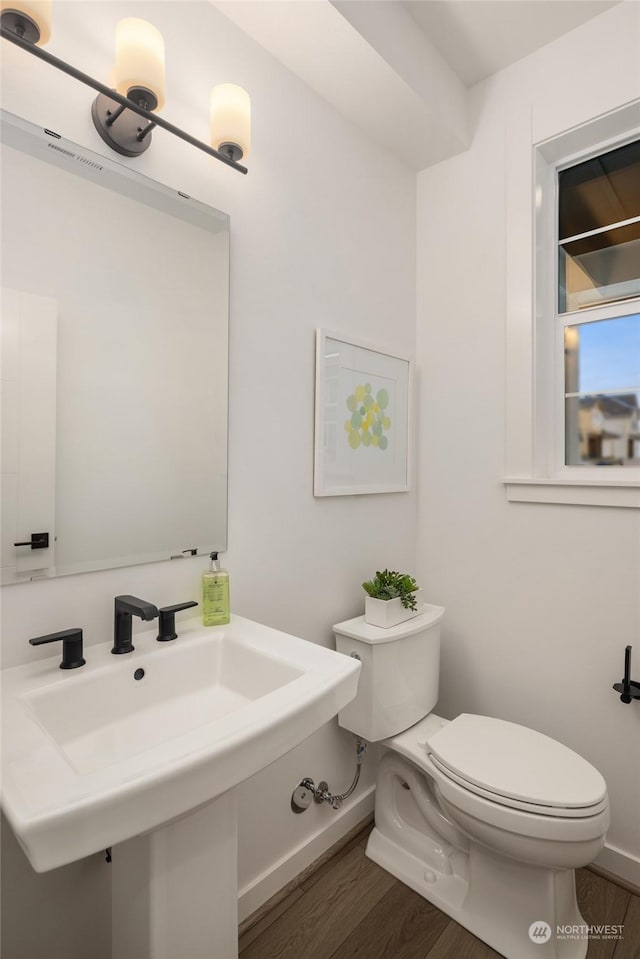 bathroom featuring hardwood / wood-style flooring and toilet