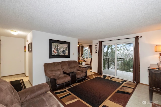 living room with light hardwood / wood-style flooring and a textured ceiling