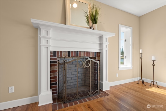 details with wood-type flooring and a brick fireplace