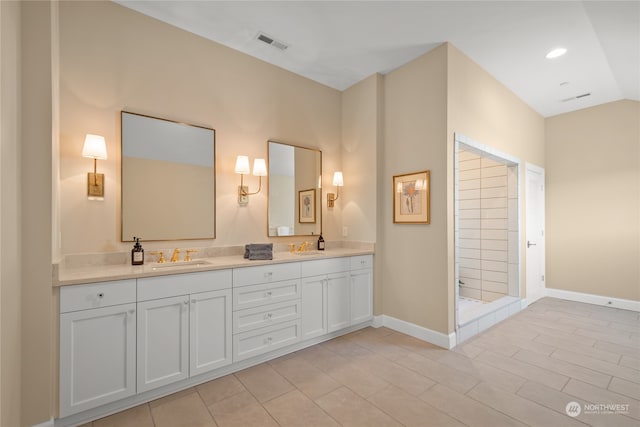 bathroom featuring vanity, walk in shower, and vaulted ceiling