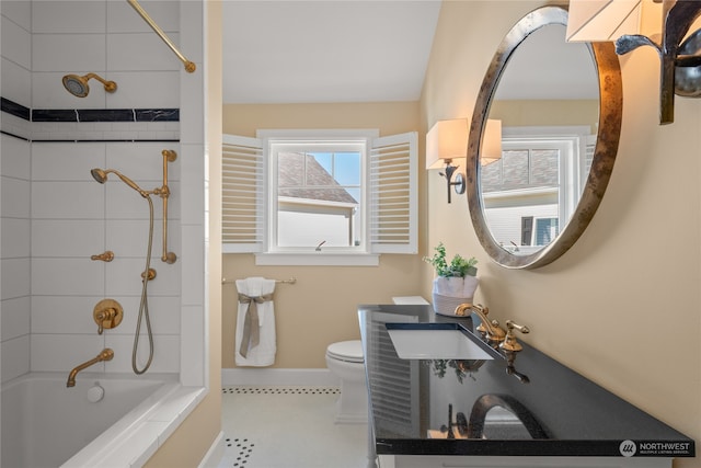 full bathroom featuring toilet, sink, and tiled shower / bath